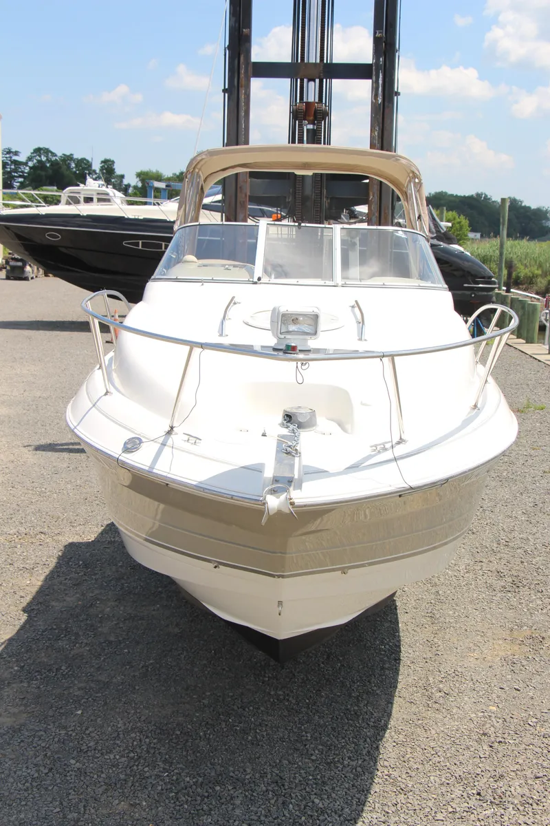 Slide: The Image of 2008 Larson Cabrio 260 boat on dry dock under sunny skies. - 6
