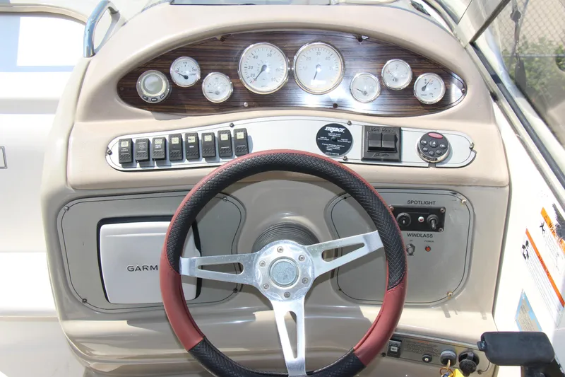 Slide: The Image of 2008 Larson Cabrio 260 dashboard with steering wheel, gauges, and control panel. - 9