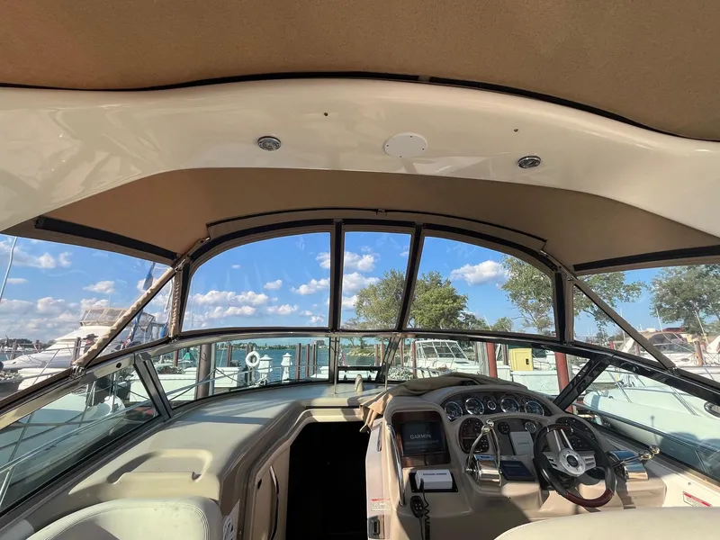 Slide: The Image of Interior view of 2002 Sea Ray 320 Sundancer boat cockpit with steering wheel and dashboard. - 11