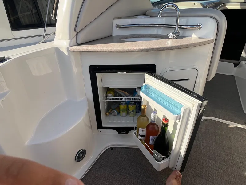 Slide: The Image of Mini fridge on 2002 Sea Ray 320 Sundancer yacht, stocked with beverages. - 16