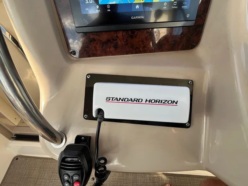 Slide: The Image of Control panel of a 2002 Sea Ray 320 Sundancer with Garmin and Standard Horizon equipment. - 19
