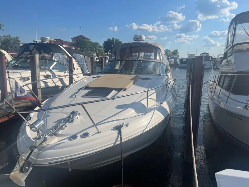 Slide: The Image of 2002 Sea Ray 320 Sundancer docked at marina under a sunny sky. - 2