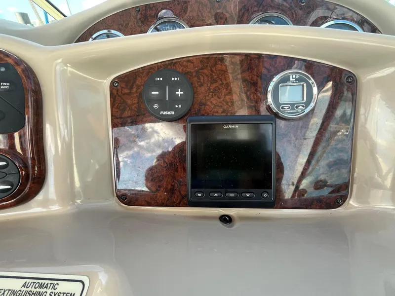 Slide: The Image of Dashboard of a 2002 Sea Ray 320 Sundancer with Garmin and Fusion controls. - 20