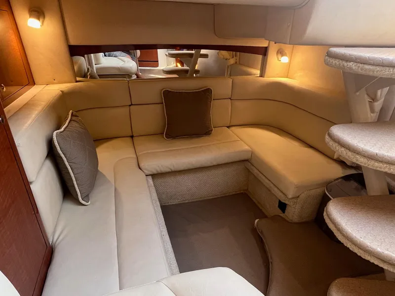 Slide: The Image of Luxurious interior of 2002 Sea Ray 320 Sundancer yacht with beige seating and ambient lighting. - 24
