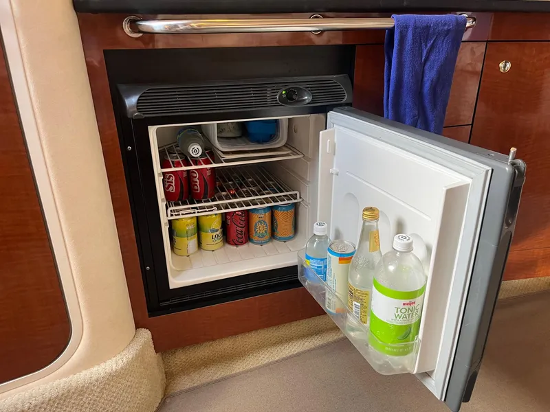 Slide: The Image of Mini fridge stocked with beverages on a 2002 Sea Ray 320 Sundancer yacht. - 26