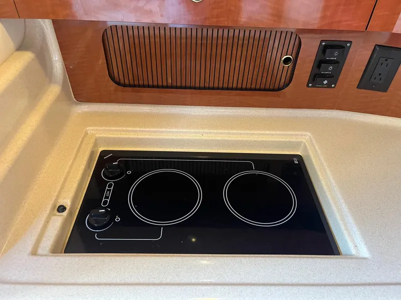 Slide: The Image of Electric stove in 2002 Sea Ray 320 Sundancer yacht kitchen area. - 27