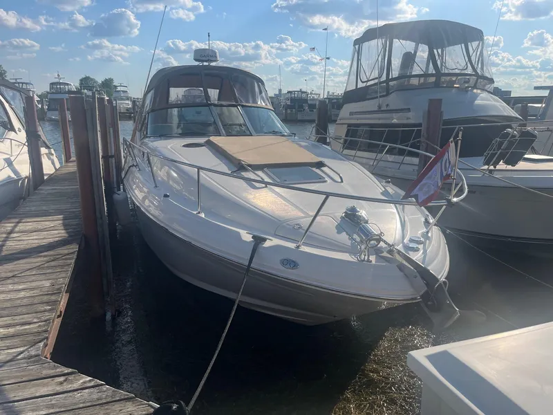 Slide: The Image of 2002 Sea Ray 320 Sundancer docked at marina under blue sky. - 3