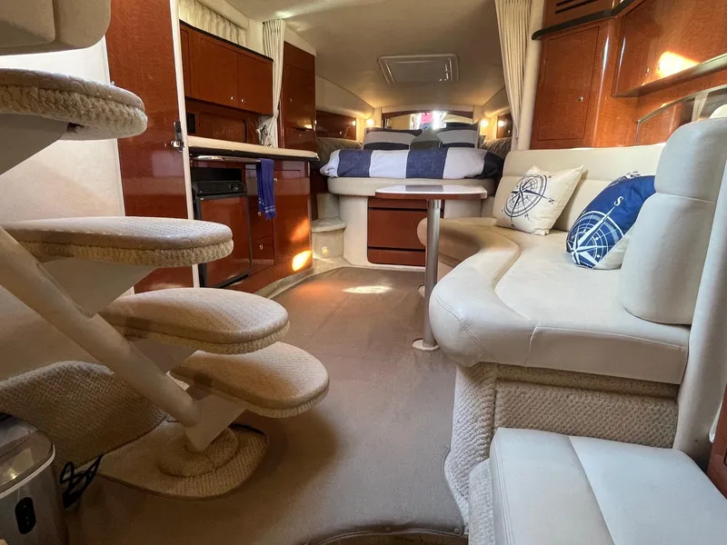 Slide: The Image of Interior of 2002 Sea Ray 320 Sundancer yacht with cozy seating and elegant design. - 31