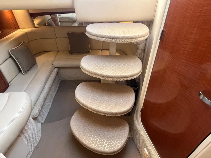 Slide: The Image of Interior of 2002 Sea Ray 320 Sundancer with curved steps and beige seating area. - 32
