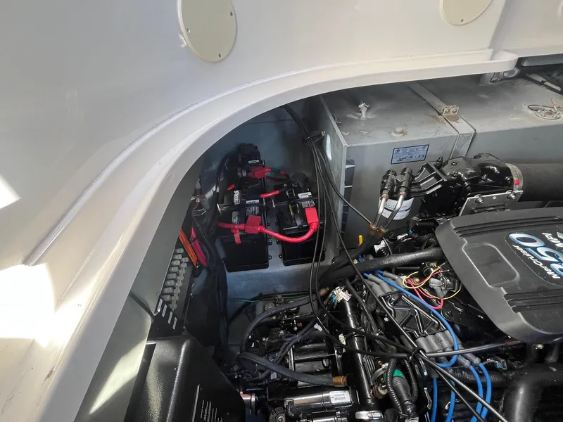 Slide: The Image of Engine compartment of a 2002 Sea Ray 320 Sundancer with visible battery and wiring. - 37