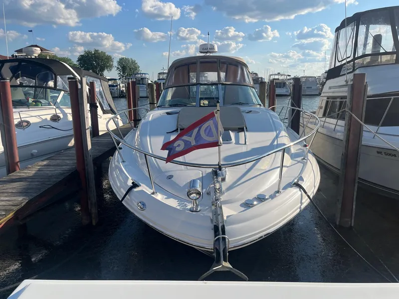 Slide: The Image of 2002 Sea Ray 320 Sundancer docked at marina under blue sky. - 4