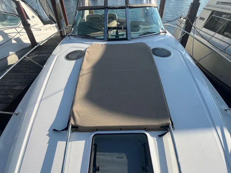 Slide: The Image of 2002 Sea Ray 320 Sundancer boat with sunpad, docked at marina. - 6