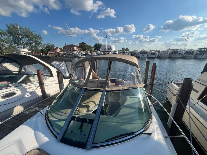 Slide: The Image of 2002 Sea Ray 320 Sundancer docked at marina under blue sky. - 7