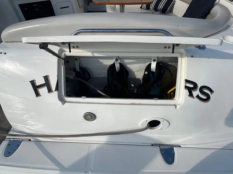 Slide: The Image of Open storage compartment on a 2002 Sea Ray 320 Sundancer boat. - 9