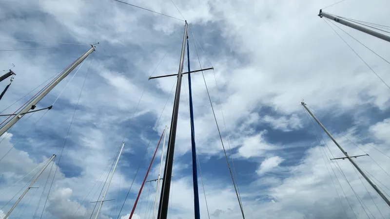 Slide: The Image of Sailboat masts against a cloudy sky, featuring S2 7.3 model from 1980. - 4