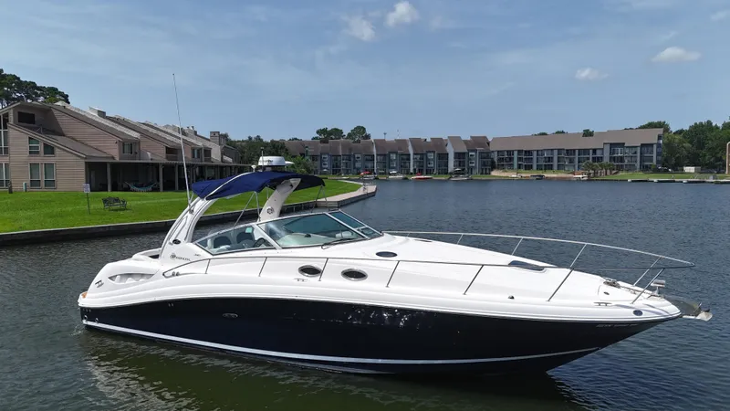 Slide: The Image of 2005 Sea Ray 340 Sundancer yacht docked near waterfront homes. - 11