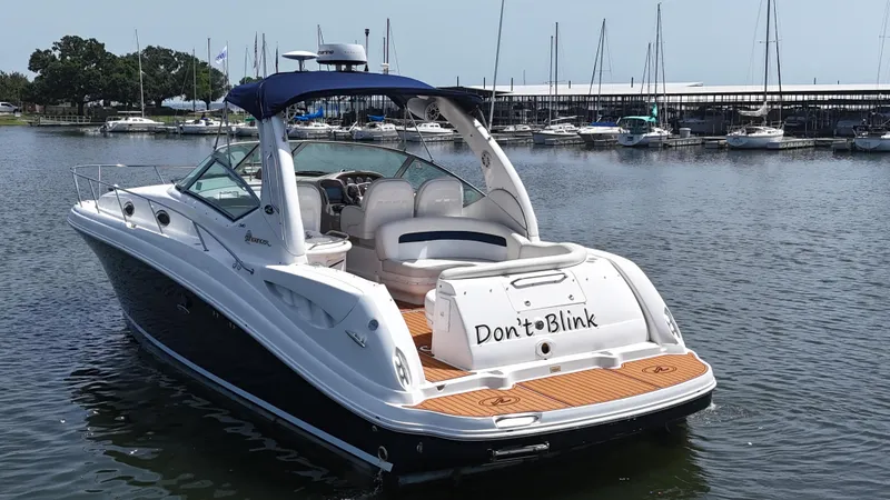 Slide: The Image of 2005 Sea Ray 340 Sundancer yacht docked in marina, featuring "Don't Blink" on the stern. - 12