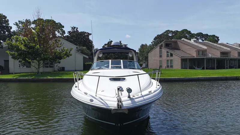 Slide: The Image of 2005 Sea Ray 340 Sundancer yacht docked near waterfront homes. - 14