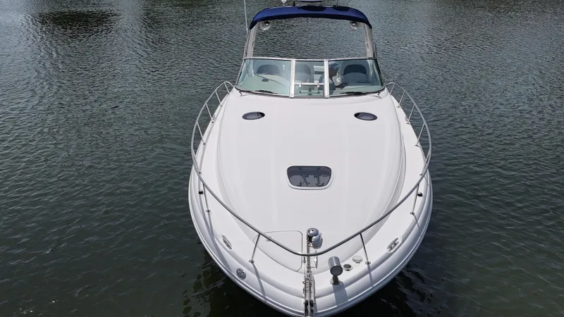 Slide: The Image of 2005 Sea Ray 340 Sundancer boat on calm water, front view. - 15