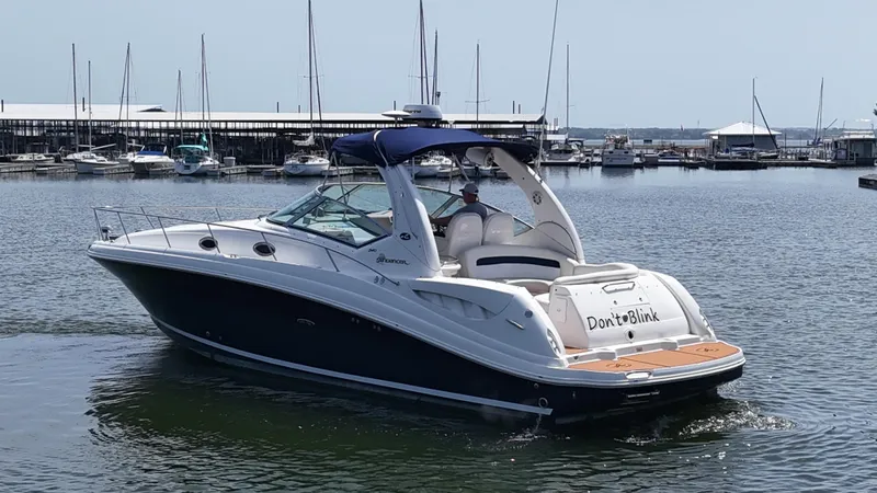 Slide: The Image of 2005 Sea Ray 340 Sundancer boat named "Don't Blink" docked in a marina. - 17