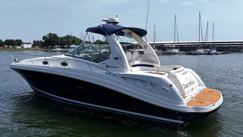 Slide: The Image of 2005 Sea Ray 340 Sundancer boat docked in marina, featuring sleek design and spacious deck. - 2