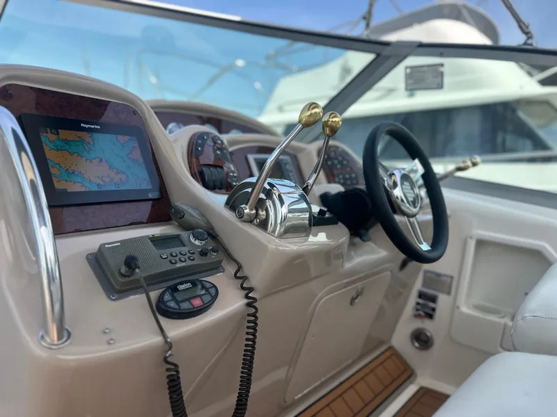 Slide: The Image of 2005 Sea Ray 340 Sundancer helm with navigation equipment and steering wheel. - 28