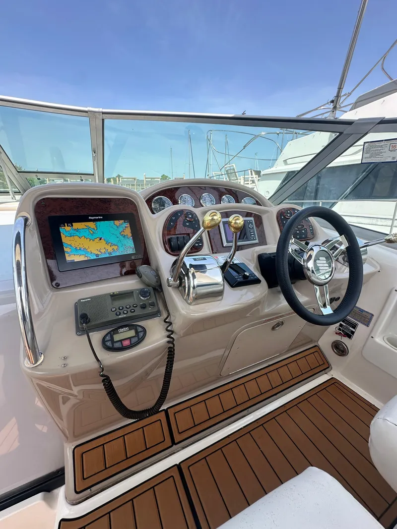 Slide: The Image of 2005 Sea Ray 340 Sundancer helm with navigation system and controls, featuring a sleek design. - 29