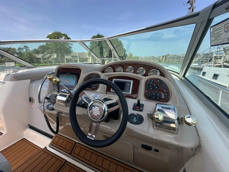 Slide: The Image of 2005 Sea Ray 340 Sundancer helm with steering wheel, controls, and navigation system. - 32