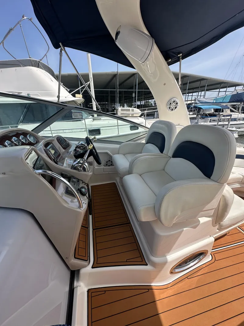 Slide: The Image of 2005 Sea Ray 340 Sundancer helm with dual seats and modern controls. - 34