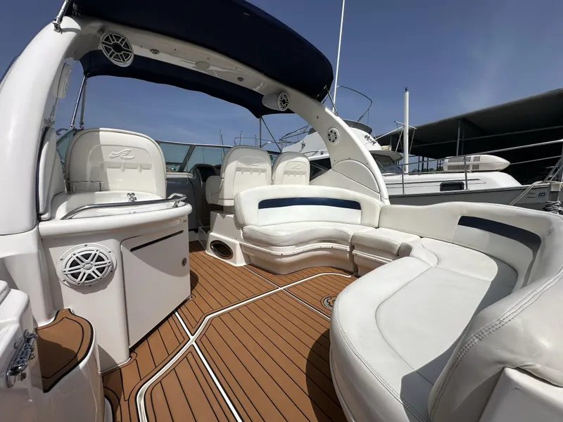 Slide: The Image of 2005 Sea Ray 340 Sundancer boat interior with white seating and wood flooring. - 35