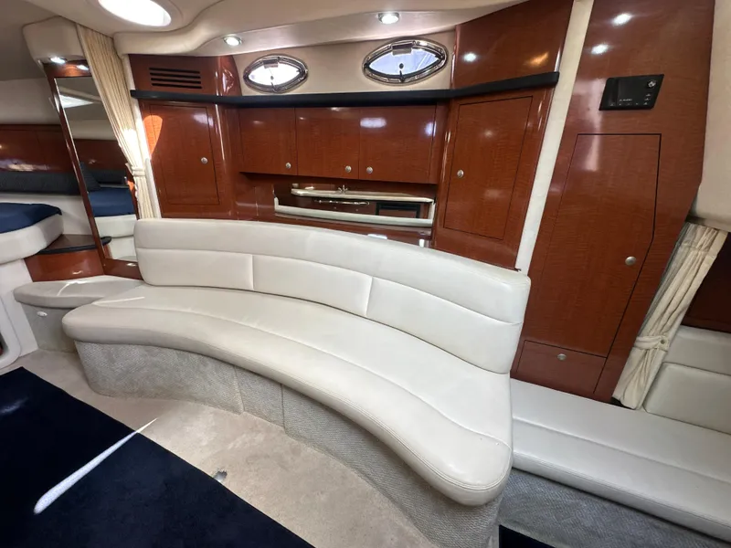 Slide: The Image of Luxurious interior of 2005 Sea Ray 340 Sundancer yacht with curved seating and wood cabinetry. - 46
