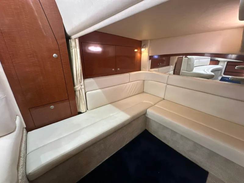 Slide: The Image of 2005 Sea Ray 340 Sundancer interior with cream leather seating and wooden cabinetry. - 49