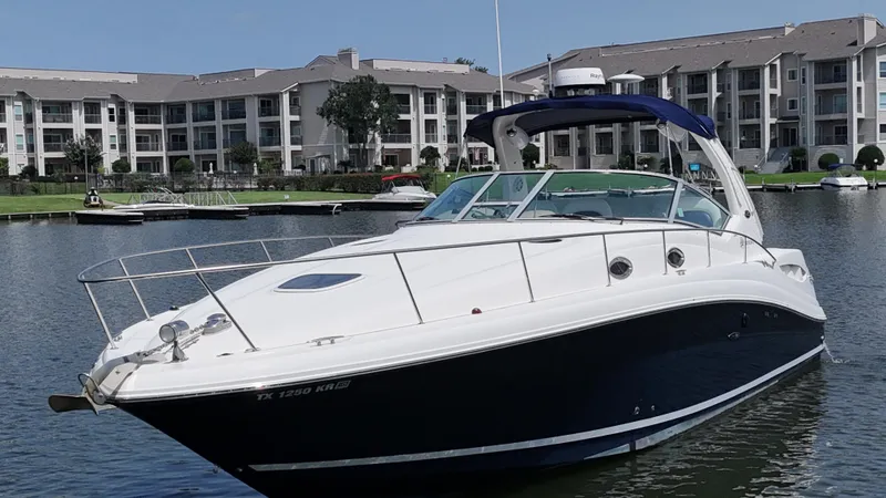 Slide: The Image of 2005 Sea Ray 340 Sundancer yacht docked near waterfront apartments. - 7