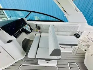 Slide: The Image of 2026 Sea Ray SDX 250 Outboard boat interior with modern seating and controls. - 12