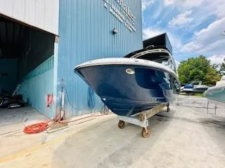 Slide: The Image of 2026 Sea Ray SDX 250 Outboard boat outside a blue warehouse. - 3