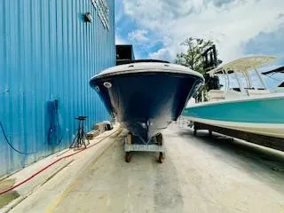 Slide: The Image of 2026 Sea Ray SDX 250 Outboard boat in marina, blue hull, clear sky. - 4