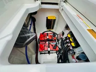 Slide: The Image of 2026 Sea Ray SDX 250 Outboard battery compartment with wiring and components. - 8