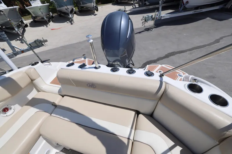 Slide: The Image of 2017 NauticStar 243DC Sport Deck boat interior with seating and outboard motor. - 11