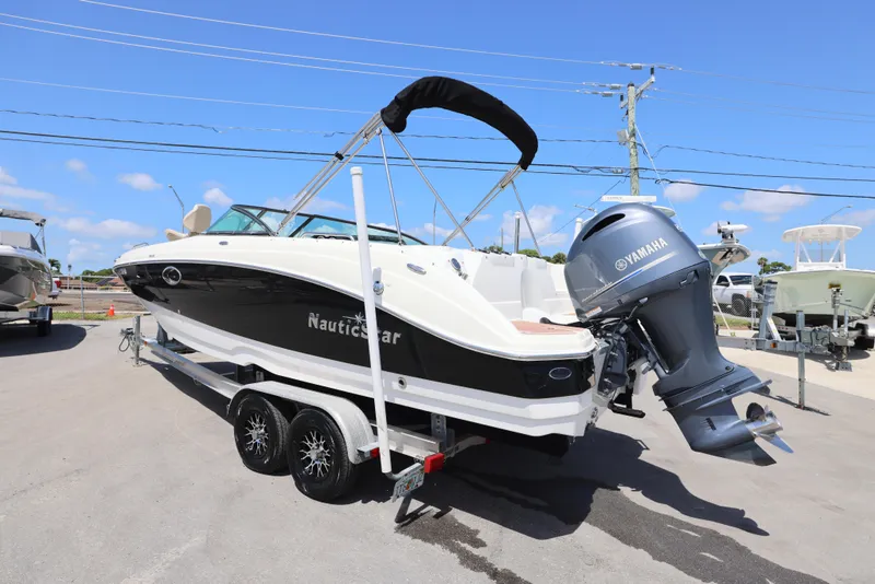 Slide: The Image of 2017 NauticStar 243DC Sport Deck boat with Yamaha engine on trailer. - 14