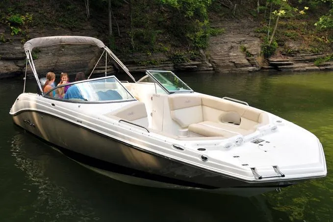 Slide: The Image of Manufacturer Provided Image: 2017 NauticStar 243DC Sport Deck boat on a calm lake with passengers. - 16
