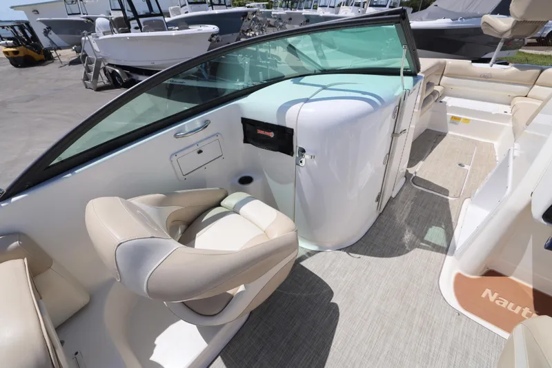 Slide: The Image of 2017 NauticStar 243DC Sport Deck interior with beige seating and modern design. - 3