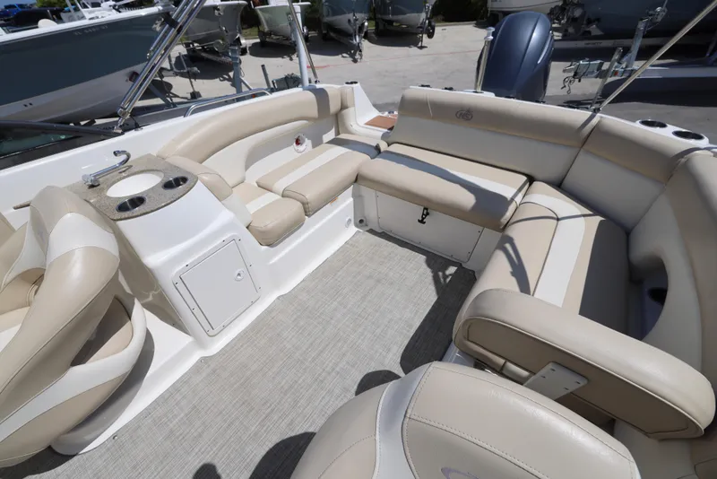 Slide: The Image of 2017 NauticStar 243DC Sport Deck interior with beige seating and cup holders. - 6