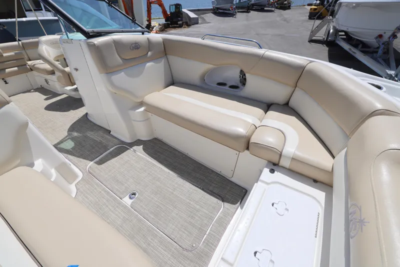 Slide: The Image of 2017 NauticStar 243DC Sport Deck interior with beige seating and spacious layout. - 7