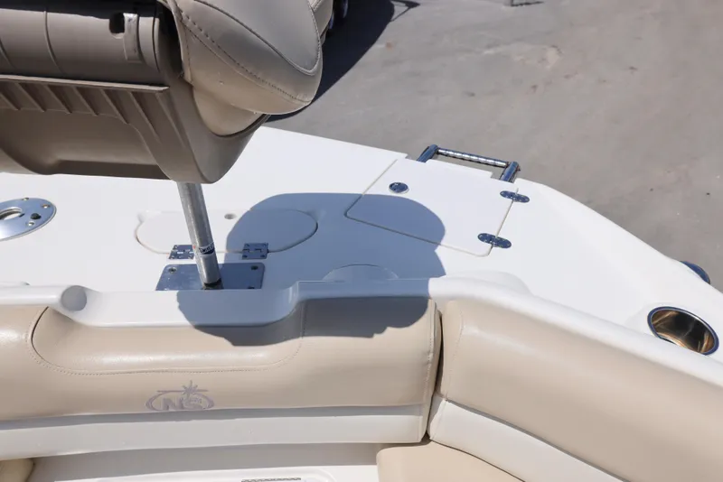 Slide: The Image of 2017 NauticStar 243DC Sport Deck boat interior with beige seating and stainless steel fixtures. - 9