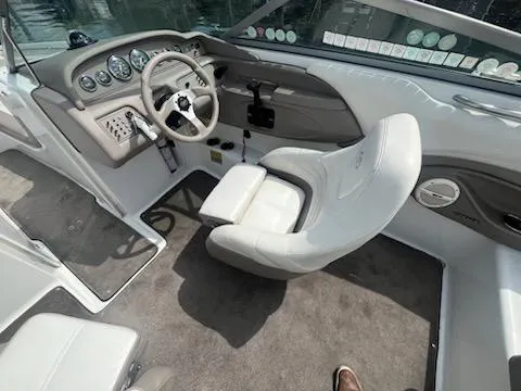 Slide: The Image of 1999 Cobalt 226 boat interior with steering wheel, dashboard, and white captain's chair. - 10