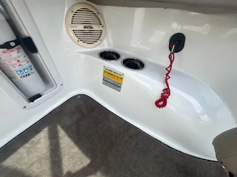 Slide: The Image of Interior of 1999 Cobalt 226 boat with speaker, cup holders, and safety equipment. - 11
