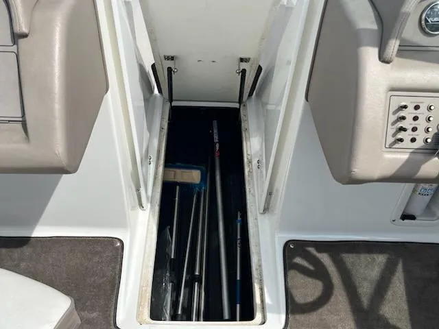 Slide: The Image of Storage compartment on a 1999 Cobalt 226 boat, containing various equipment. - 15