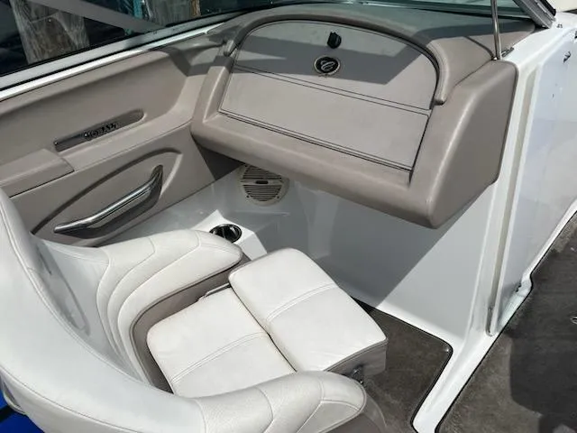 Slide: The Image of Interior of a 1999 Cobalt 226 boat with beige seating and dashboard. - 16