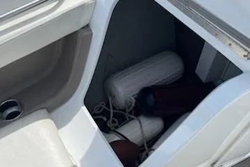 Slide: The Image of Storage compartment on a 1999 Cobalt 226 boat with fenders and ropes. - 19
