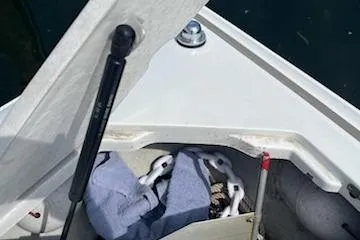 Slide: The Image of Open anchor locker on 1999 Cobalt 226 boat with chain and towel inside. - 22